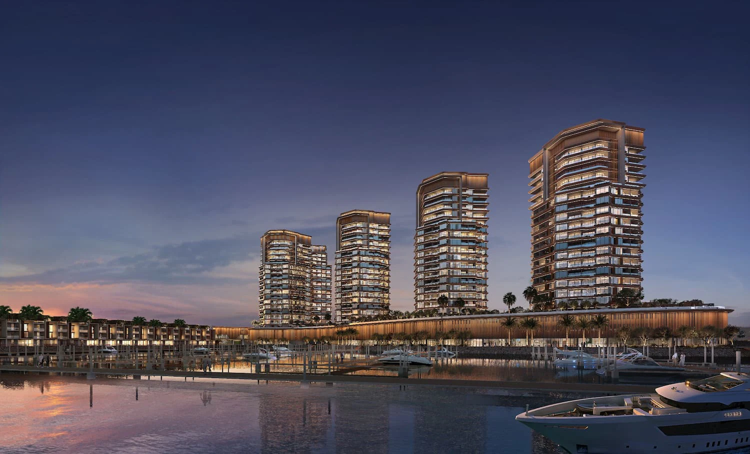 Al Hamra Waterfront marina and residential towers at dusk